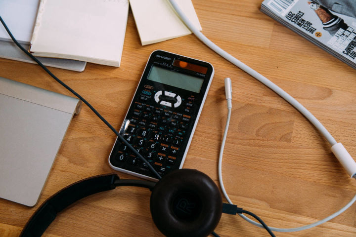 Open desk with papers and a scientific calculator